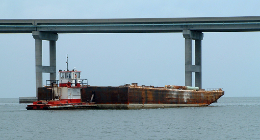 test barge being positioned by boat